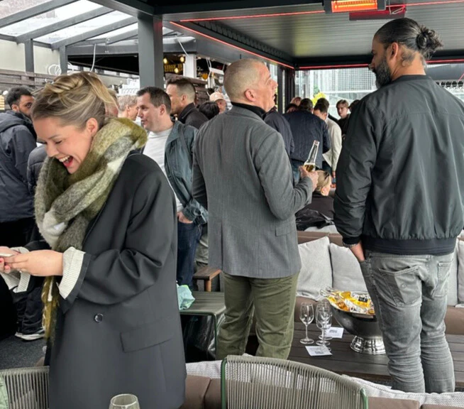 Crowd laughing and connecting during AI BAREN mingle.