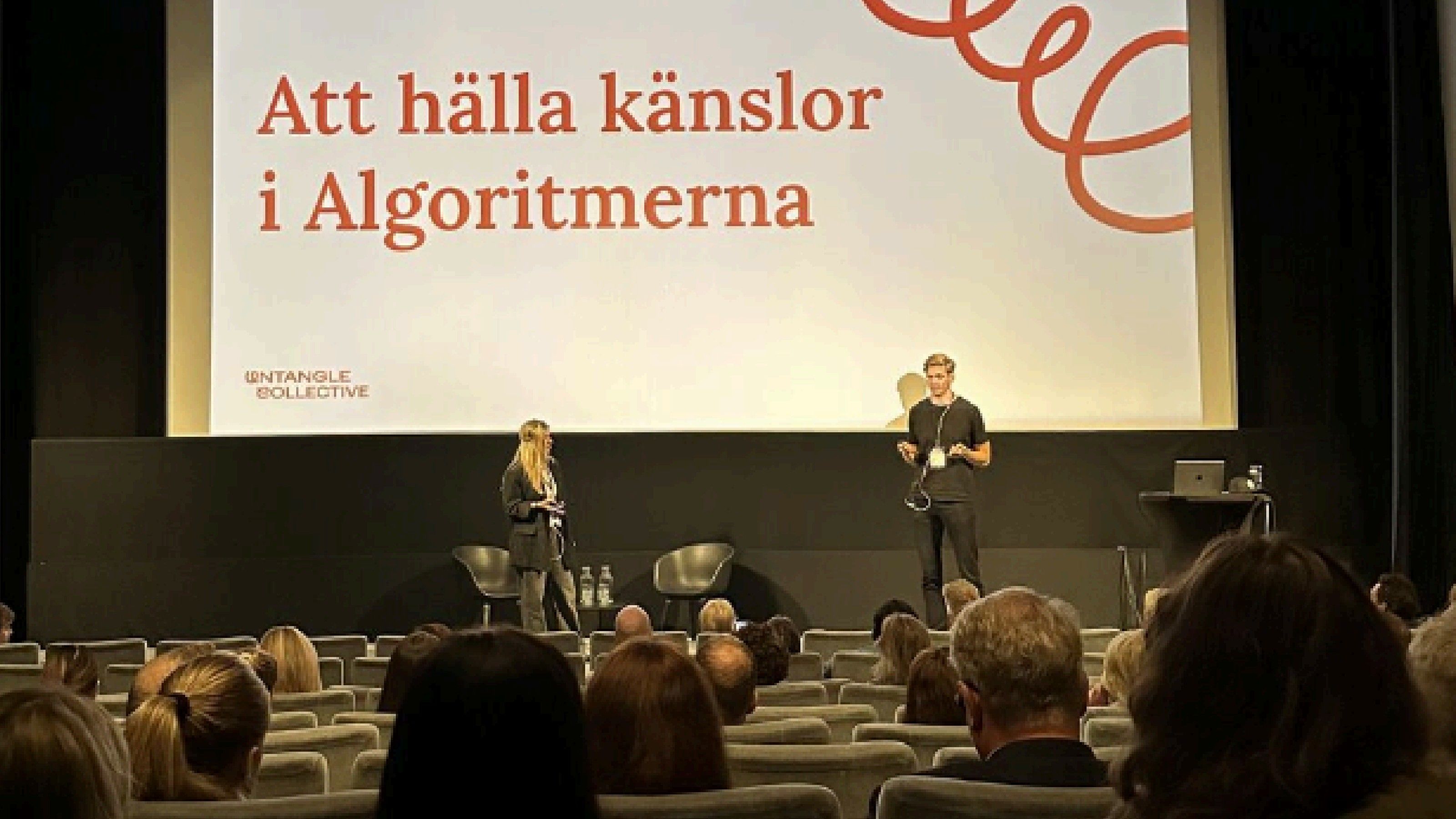 Sophia Båge and Lucas Östergren on stage presenting Untangle Collective.